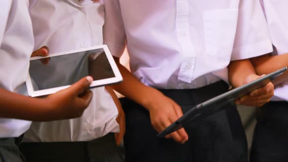 Students using digital tablet in classroom