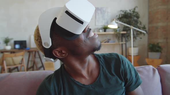 Happy Black Man Enjoying Augmented Reality with VR Glasses