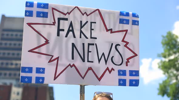 Female Hand Holding Banner in Hand in Protest