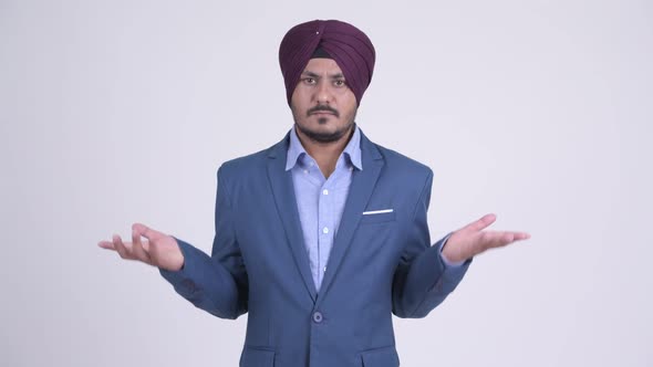 Confused Bearded Indian Sikh Businessman Shrugging Shoulders