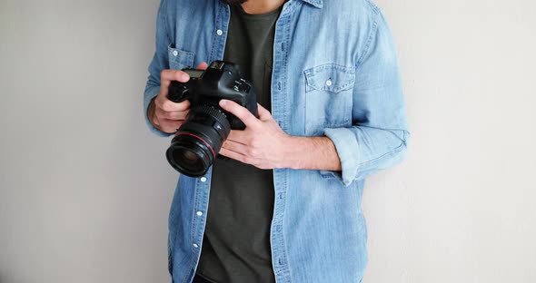 Photographer looking at photos on digital camera