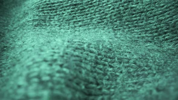 Extreme detail view of sheep wool cloth texture flowing in macro dolly shot.