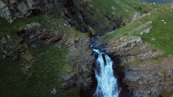 Aerial view of a mountain waterfall during spring