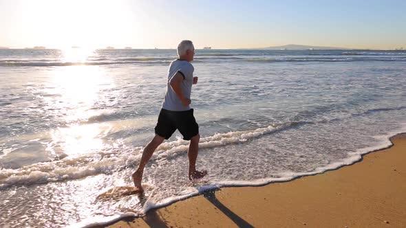 Senior Man Exercising At The  Beach