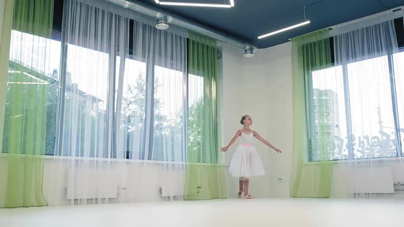 Graceful Girl in Skirt Dances Classical Ballet in Studio