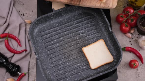 Toasting Slices of Toast Bread in a Grill Frying Pan