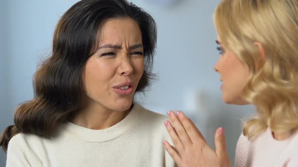 Attentive Asian Woman Listening to Problems of Her Caucasian Friend, Shock