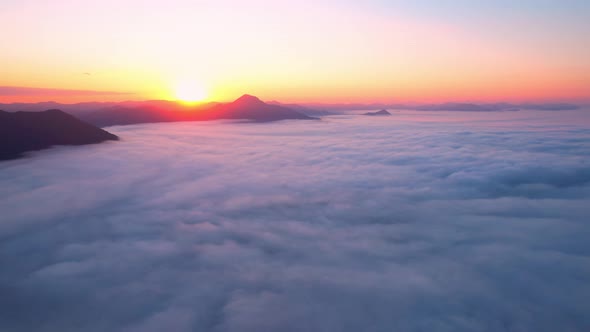 4K Drone Flying through the clouds at dusk or dawn. Aerial top cloudscape