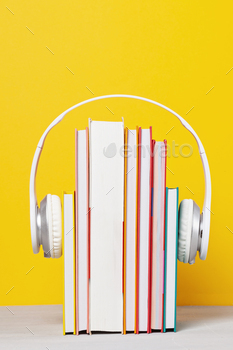 Group of books with the earphones. Audiobooks concept