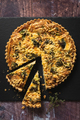 Top down view of a delicious broccoli quiche on black slate background on wooden table - PhotoDune Item for Sale