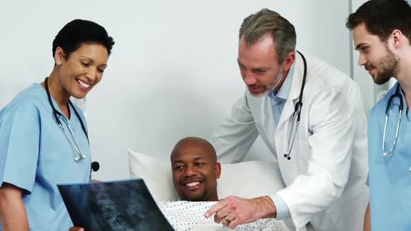 Doctors showing a x-ray report to the patient