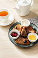 Delicious thin pancakes with jam, honey and sour cream and cup of tea on light wooden table - PhotoDune Item for Sale