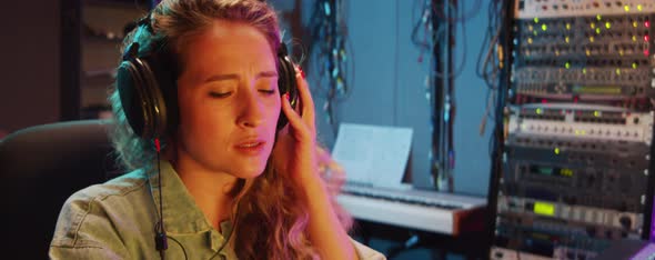 Woman Using Mixing Console in Recording Studio