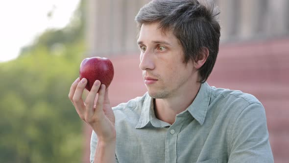 Young Millennial Man Wants to Eat Apple but Cannot