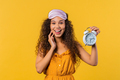 Happy smiling woman on yellow with alarm clock.Early morning.correct day routine - PhotoDune Item for Sale