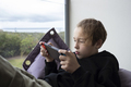 Boy teenager being attracted with game on handheld console - PhotoDune Item for Sale