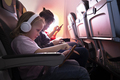 Kids with gadgets in the airplane - PhotoDune Item for Sale