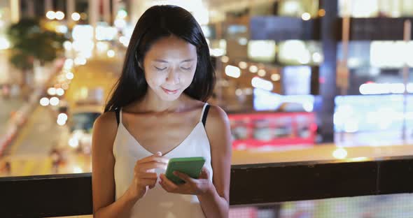 Woman use of smart phone at night 