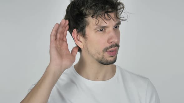 Young Casual Man Listening Secret White Background