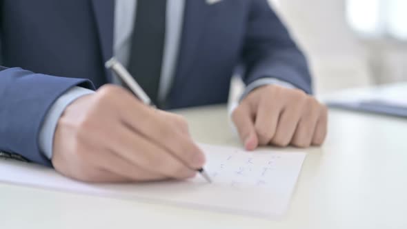 Businessman Writing on Paper