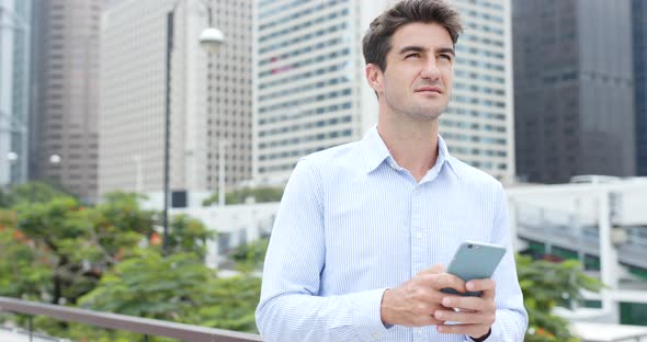 Man use of mobile phone in Hong Kong city