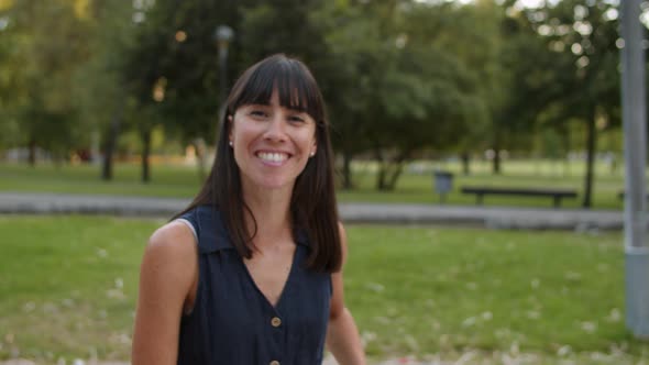 Happy Beautiful Black Haired Woman Standing in City Park