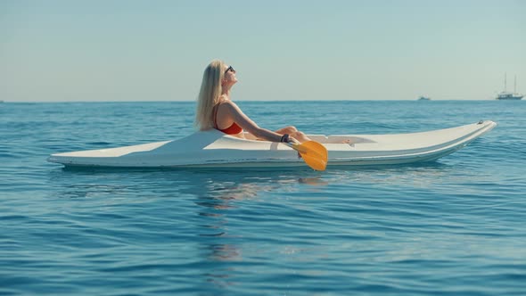 Paddling Canoe Adventure. Tourist Woman Spending Day Kayaking On Sea. Journey On Kayaking Summer.