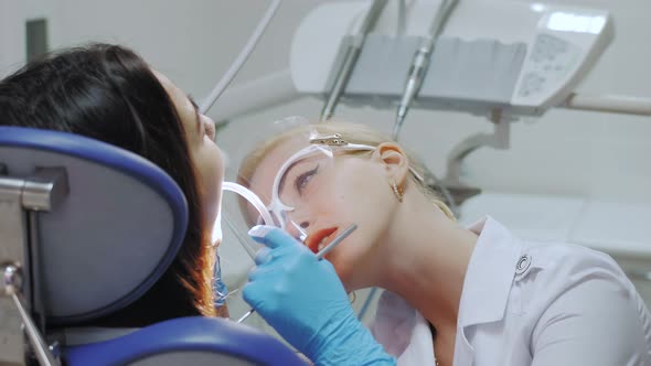 A Dentist Drills a Tooth