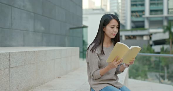 Woman read book at outdoor