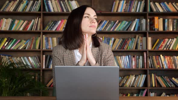 Businesswoman with Short Dark Hair Against Racks with Books