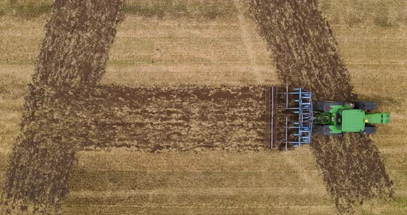 Tractor Makes An Inscription In The Field. Plow