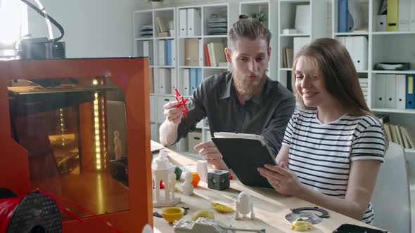 Designers Using Tablet and Working with 3D Printing Machine