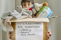 Happy kid supporting a box with humanitarian aid for a natural disaster victims - PhotoDune Item for Sale