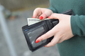 Woman hands with red nails holds black mens purse with many US hundred dollars - PhotoDune Item for Sale