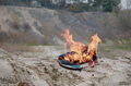 Burning sports sneakers or gym shoes on fire stand on sandy beach coast - PhotoDune Item for Sale
