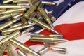 Many yellow 9mm and 5.56mm bullets and cartridges on United States flag - PhotoDune Item for Sale