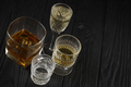 Different alcohol drinks in glass on wooden surface on dark background - PhotoDune Item for Sale