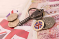 UK money bills and key for house close up. Big amount of United Kingdom pounds - PhotoDune Item for Sale