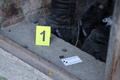 Evidence with yellow CSI marker for evidence numbering on the residental backyard - PhotoDune Item for Sale