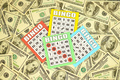 Many bingo boards or playing cards for winning chips and big amount of dollar bills - PhotoDune Item for Sale