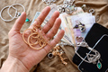 Marauders hand with bunch of stolen jewelry, money and smartphones - PhotoDune Item for Sale