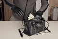 Robber in black outfit and gloves see in opened stolen women bag - PhotoDune Item for Sale