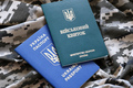 Ukrainian military ID and foreign passport on fabric with texture of pixeled camouflage - PhotoDune Item for Sale