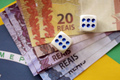 Dice cubes with brazilian money bills on flag of Brasil Republic - PhotoDune Item for Sale