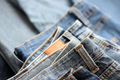 Many jeans in stack in wardrobe room - PhotoDune Item for Sale
