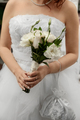 Closeup portrait of bride holding bouguet of white flowers on wedding day - PhotoDune Item for Sale