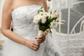 Bride holding bouquet of white flowers on Wedding day - PhotoDune Item for Sale