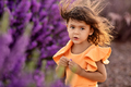 Summer portrait of toddler girl standing around blooming purple flowers - PhotoDune Item for Sale