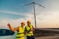 Workers looking and checking wind turbines at field - PhotoDune Item for Sale