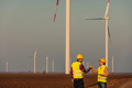 Two Engineers shaking hands at windmill farm - PhotoDune Item for Sale